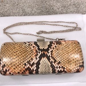 Charming Charlie’s snake canvas clutch